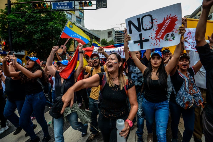 Opposition activists shout slogans in the capital of Caracas on May 7.