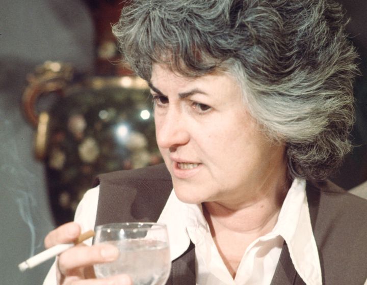 Bea Arthur holds a wine glass and a cigarette in a scene from "Maude."