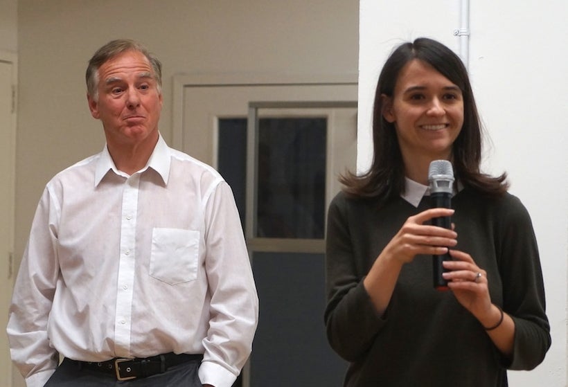 Howard Dean listens as Leah Greenberg, co-founder of Indivisible speaks to the crowd at Knotel on 26th street.
