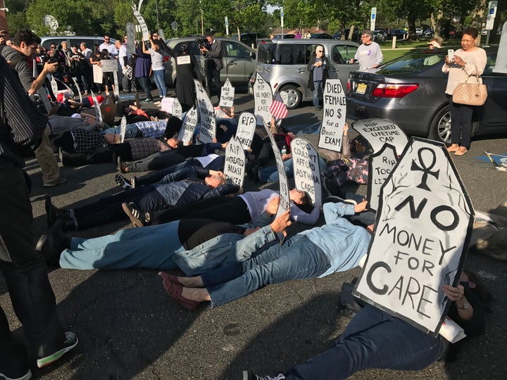 Demonstrators hold a “die-in” outside the town hall Rep. Tom MacArthur held in New Jersey on Wednesday.