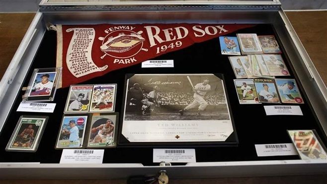 Sports memorabilia is part of an auction of abandoned safe deposit box contents conducted by the Massachusetts Treasurer’s Office in 2015. State officials say residents should contact them if they think they have abandoned property and be wary of scammers who promise to reunite them with lost property for an upfront fee.