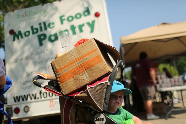 A child waits at a food bank distribution site in Oswego, New York, in 2012. Rural communities are sometimes overlooked when it comes to America's hunger problem.