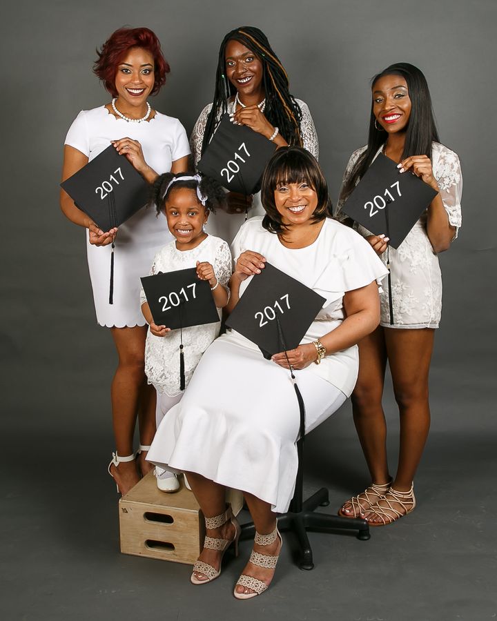From left to right, Amari, Paris and Jade stand behind Flennoy and her granddaughter.