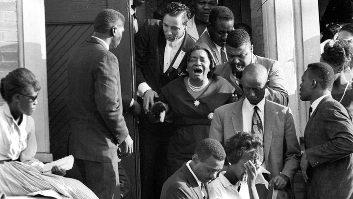 Mourners exit the funeral for the victims of the 16th Street Baptist Church in 1963.