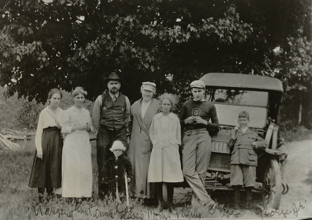 A teenage Hemingway, second from the left, wearing his high school logo.