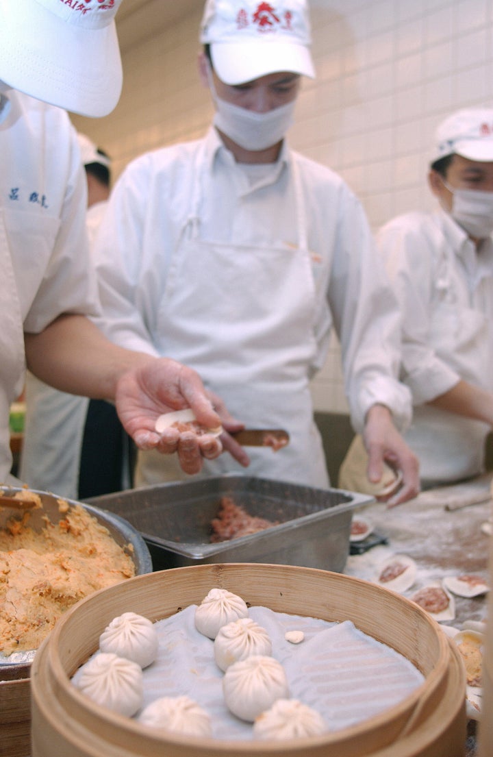 Din Tai Fung chefs fill dumplings with minced pork at the restaurant's Taiwan location.