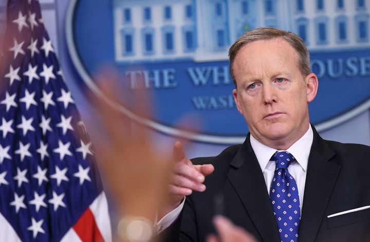 Reporters raise their hands with questions as White House press secretary Sean Spicer speaks during the daily briefing in the Brady Briefing Room of the White House on May 9.