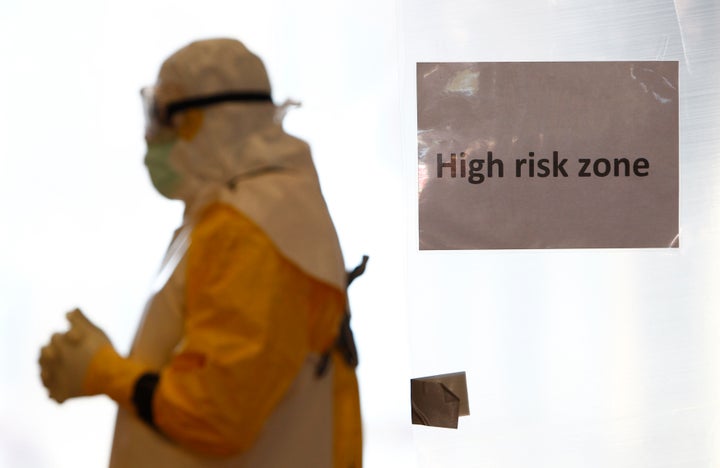 A volunteer wearing a protective suit walks in a "high-risk" zone during an Ebola training session held by Germany's Red Cross on Oct. 21, 2014.