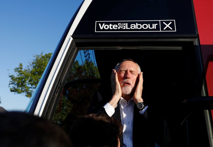 Jeremy Corbyn reacts as he gets on a bus after a campaign event in Leeds.