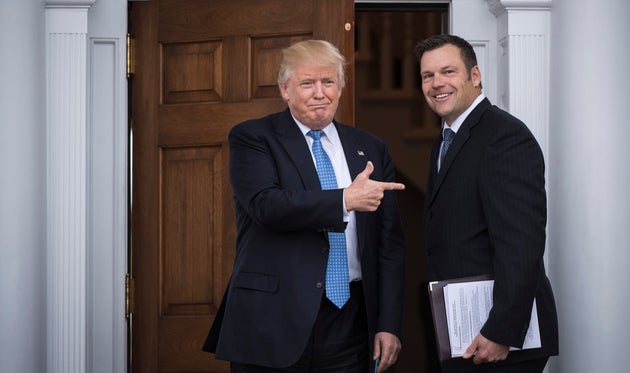 Kansas Secretary of State Kris Kobach (right) has a long history of stoking fears of voter