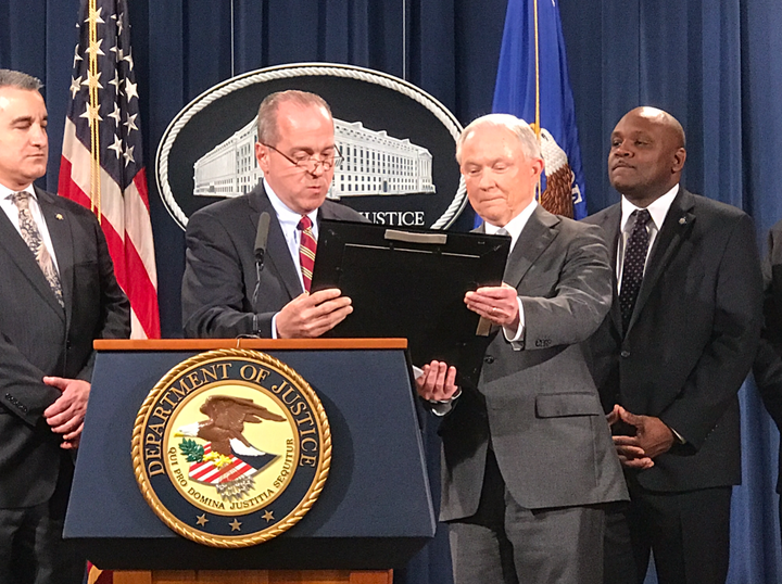 Union president Edward Mullins gives Attorney General Jeff Sessions an award.