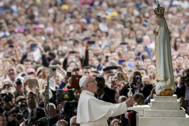 Pope Francis offers a golden rose to Our Lady of Fatima at the Chapel of the Apparitions at the Shrine of Our Lady of Fatima in Portugal May 12, 2017.