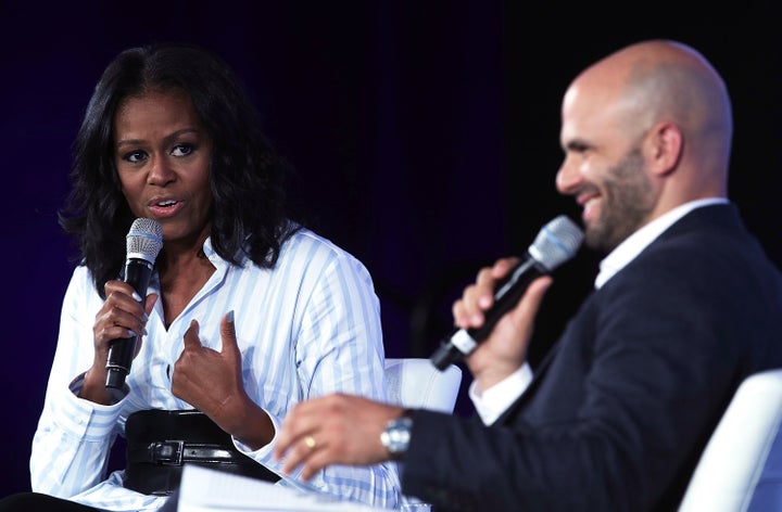 Former first lady Michelle Obama talks with former White House chef Sam Kass during the Partnership for a Healthier Amer