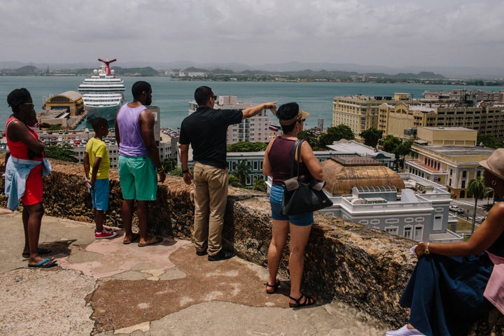 People look out over the Old City of San Juan, Puerto Rico, on Wednesday, July 8, 2015. A growing number of Republicans in the U.S. Congress are saying they want to support Puerto Rico as it wrestles with an escalating debt crisis, though they've stopped short of backing legislation allowing for municipal bankruptcy. Photographer: Christopher Gregory/Bloomberg via Getty Images