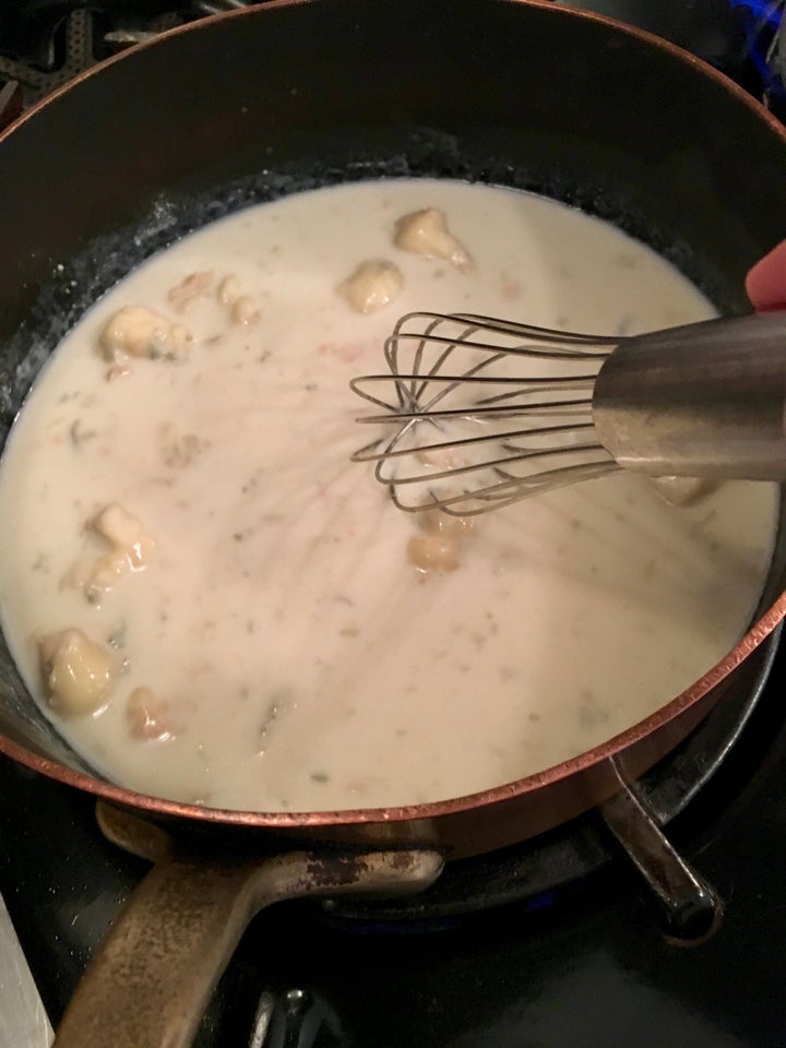 <p>Melting the gorgonzola into a half cup of milk</p>
