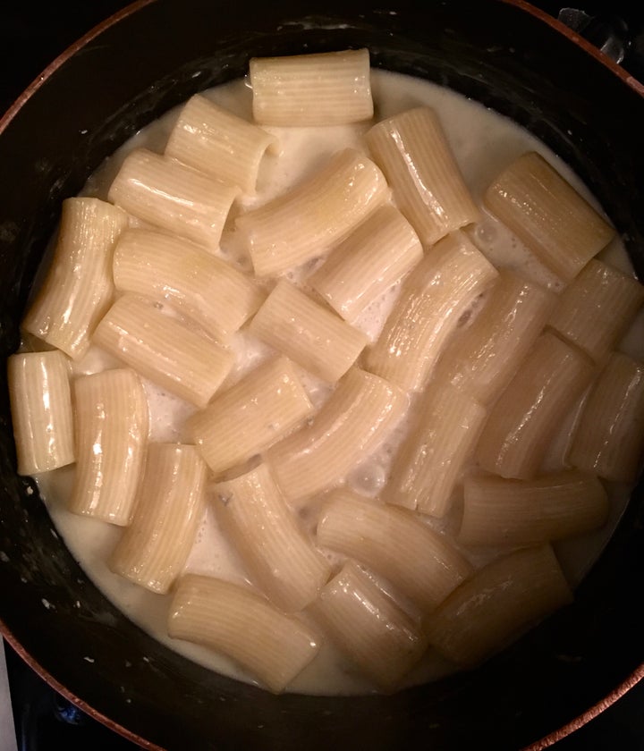 Nearly-done rigatoni finish cooking in gorgonzola sauce