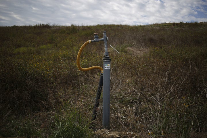 A methane gas well sticks out from the ground at the Waste Management Inc. Skyline Landfill in Ferris, Texas, U.S., on Monday