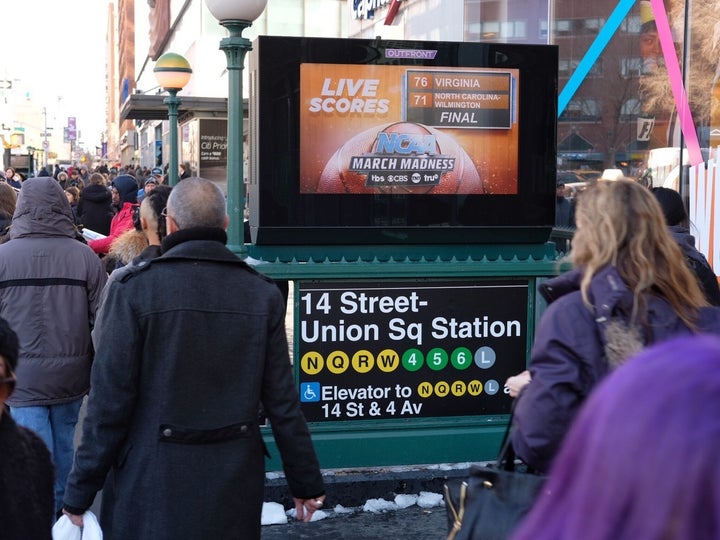 College basketball scores on OUTFRONT Media screen, New York City