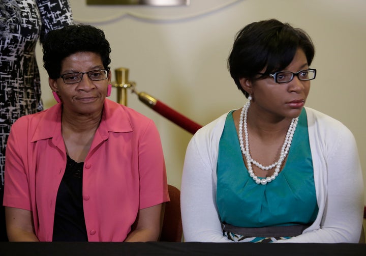 Sandra Bland's mother, Geneva Reed-Veal, left, and sister Sharon Cooper, right, attend a news conference in Lisle, Illinois, days after Bland's death.