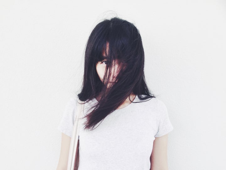 Person with hair covering half of face.