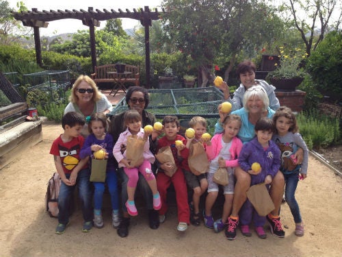 Kids and elders grow fruits and vegetables together at a preschool in San Diego County.