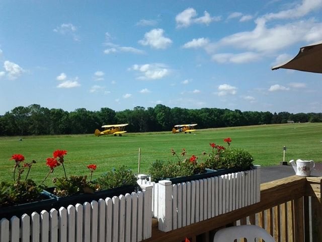 Biplanes take off on the grass airstrip at Van Sant Airport.