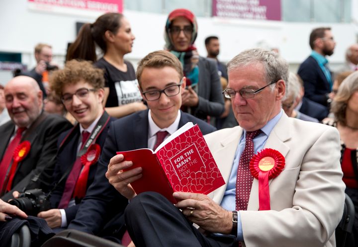 Labour supporters read the manifesto.