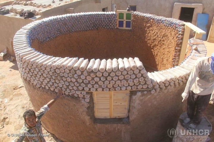 Workers construct one of the new houses, conceived by Tateh Lehbib to be weather-resistant, eco-friendly homes to stand up to the sandstorms and flooding that damage houses built from traditional adobe bricks.