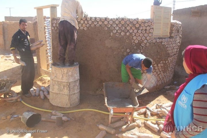 Workers construct one of the new houses.