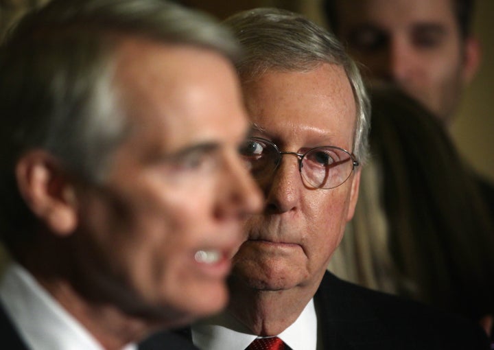 Senate Majority Leader Sen. Mitch McConnell listens as Sen. Rob Portman (L) speaks during a media briefing after the Senate Republican weekly policy luncheon at the U.S. Capitol.