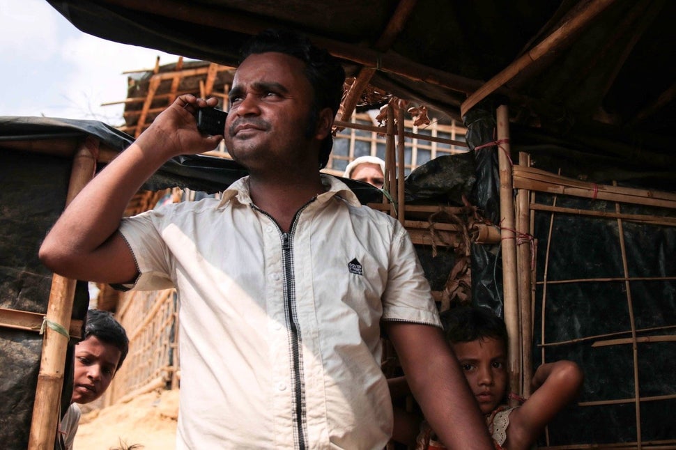 Nur Kabir takes a call from a patient. He sees an estimated 30 patients a day, sometimes simply dropping in to check that the