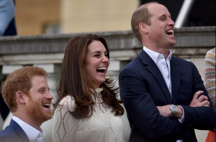 Prince Harry, Catherine, Duchess of Cambridge and Prince William, Duke of Cambridge laugh as they host a tea party on May 13. 