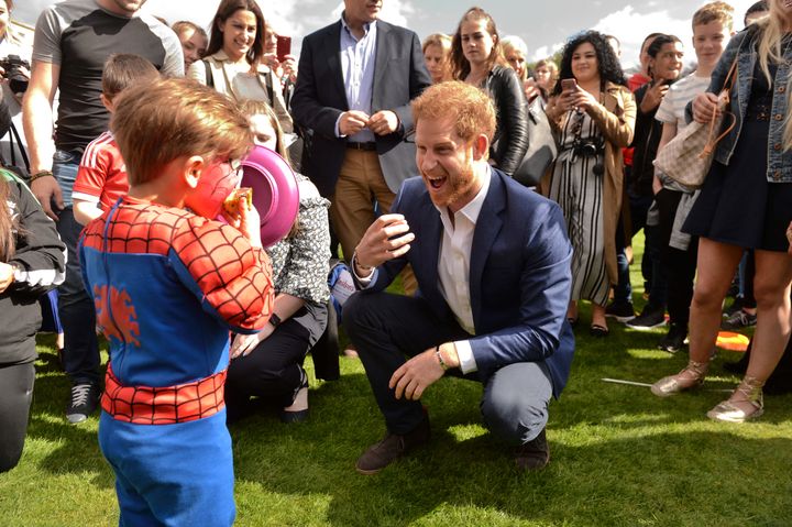 Prince Harry speaking to a young Spiderman