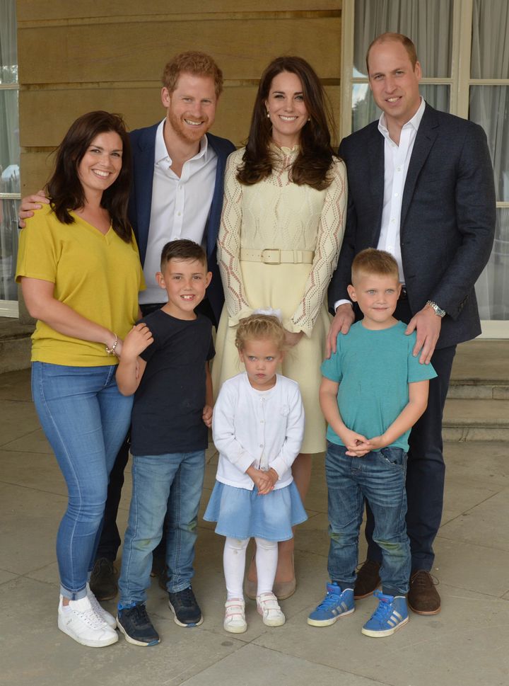 Prince Harry, Catherine, Duchess of Cambridge and Prince William stand backstage with Samantha Davidson and her children, Jayden, 8, Jamie, 6, Amelia, 4.