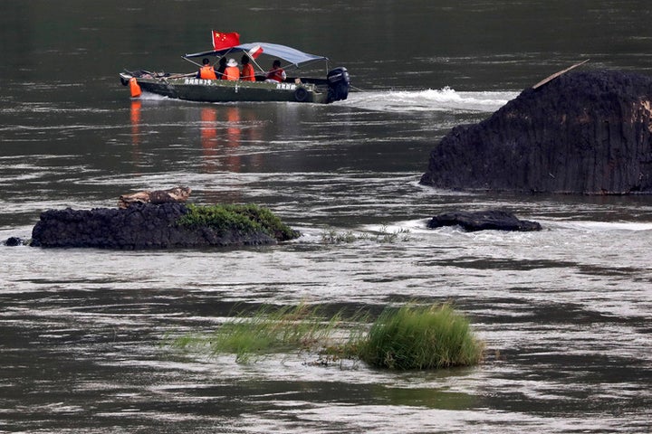 A Chinese boat, with a team of geologists, surveys the Mekong River, at the border between Laos and Thailand.