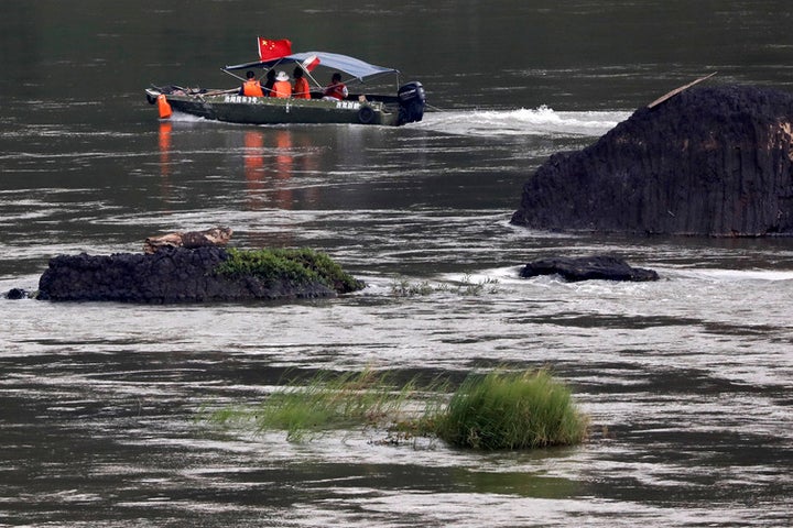  A Chinese boat, with a team of geologists, surveys the Mekong River, at the border between Laos and Thailand. 