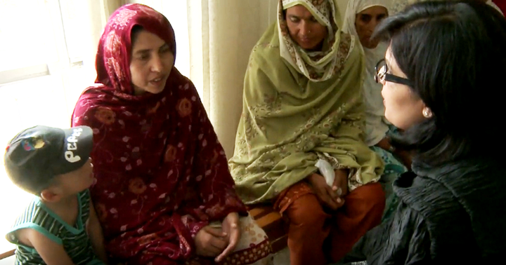 <p>Dr. Sania Nishtar at a health clinic meeting with women and children in Islamabad</p>