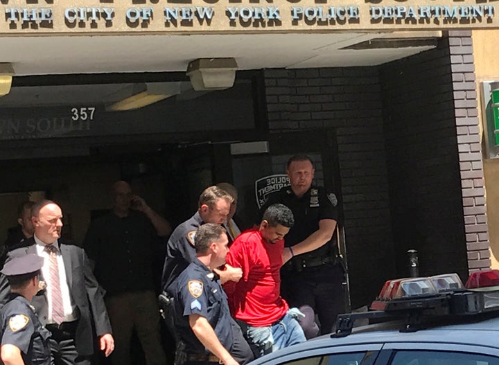 A man who police said was the suspected driver of a car which crashed into a crowd on Times Square, is led out of the NYPD Midtown South precinct in New York, U.S., May 18, 2017. REUTERS/Rodrigo Campos