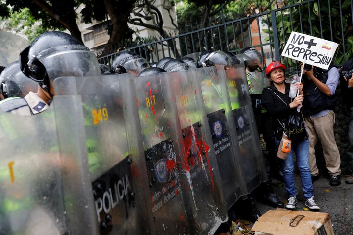 Opposition supporters confront riot security forces while rallying against President Nicolas Maduro in Caracas, Venezuela, May 12, 2017.