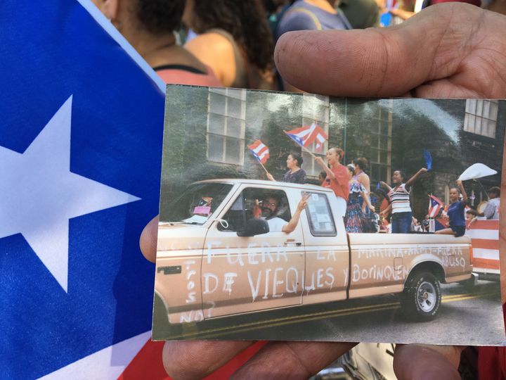Oscar Lopez Rivera supporter Moses Cintron holds a photo of his truck painted with supportive messages.