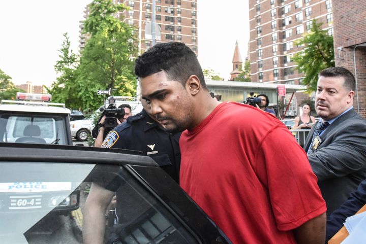 Richard Rojas is escorted from the 7th precinct by police officers 