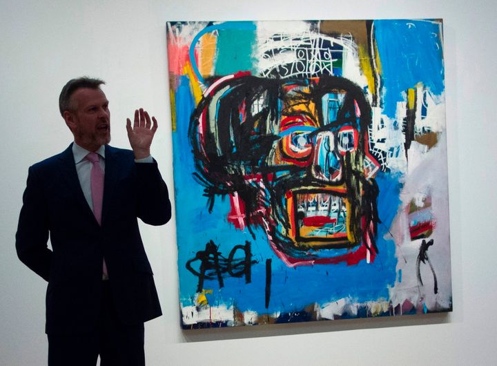 A Sotheby's official speaks about an untitled painting by Jean-Michel Basquiat during a media preview May 5, 2017 at Sotheby's In New York. 