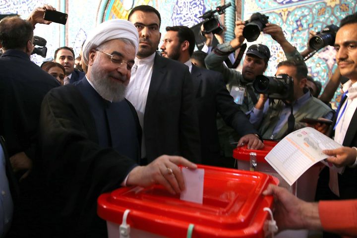 Iran's current President and presidential candidate Hassan Rouhani casts his ballot at a polling station during Iran's 12th presidential election in Tehran on May 19, 2017.