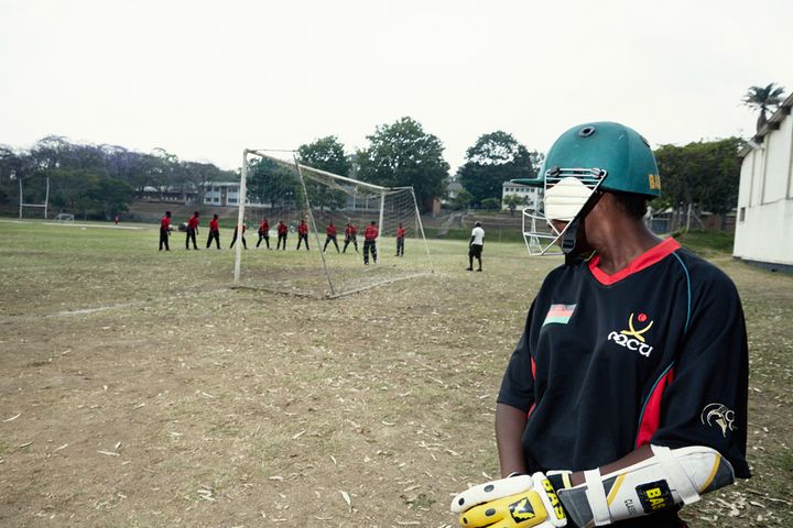 Batsman Dalida watches the Men’s National Cricket Team during batting practice, Malawian U19 Women’s Cricket Team, Blantyre, Malawi, 2016.