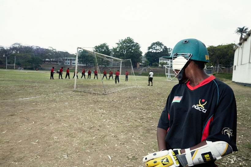 Batsman Dalida watches the Men’s National Cricket Team during batting practice, Malawian U19 Women’s Cricket Team, Blantyre,