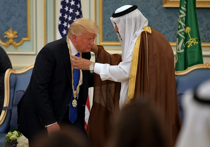 President Donald Trump (C) receives the Order of Abdulaziz al-Saud medal from Saudi Arabia's King Salman bin Abdulaziz al-Saud (R) at the Saudi Royal Court in Riyadh on May 20, 2017.