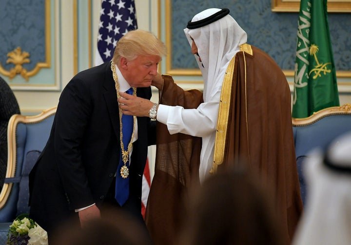 President Donald Trump (C) receives the Order of Abdulaziz al-Saud medal from Saudi Arabia's King Salman bin Abdulaziz al-Sau