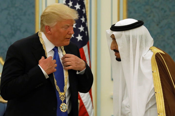 Saudi Arabia's King Salman bin Abdulaziz Al Saud, right, presents President Donald Trump with the country's highest honor.&nb