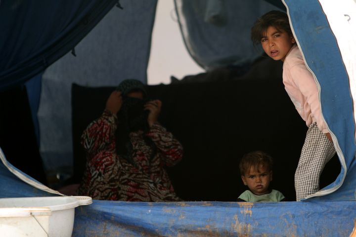 Internally displaced Syrians who fled the city of Raqqa rest in a tent in Manbij, Syria, on April 6, 2017.