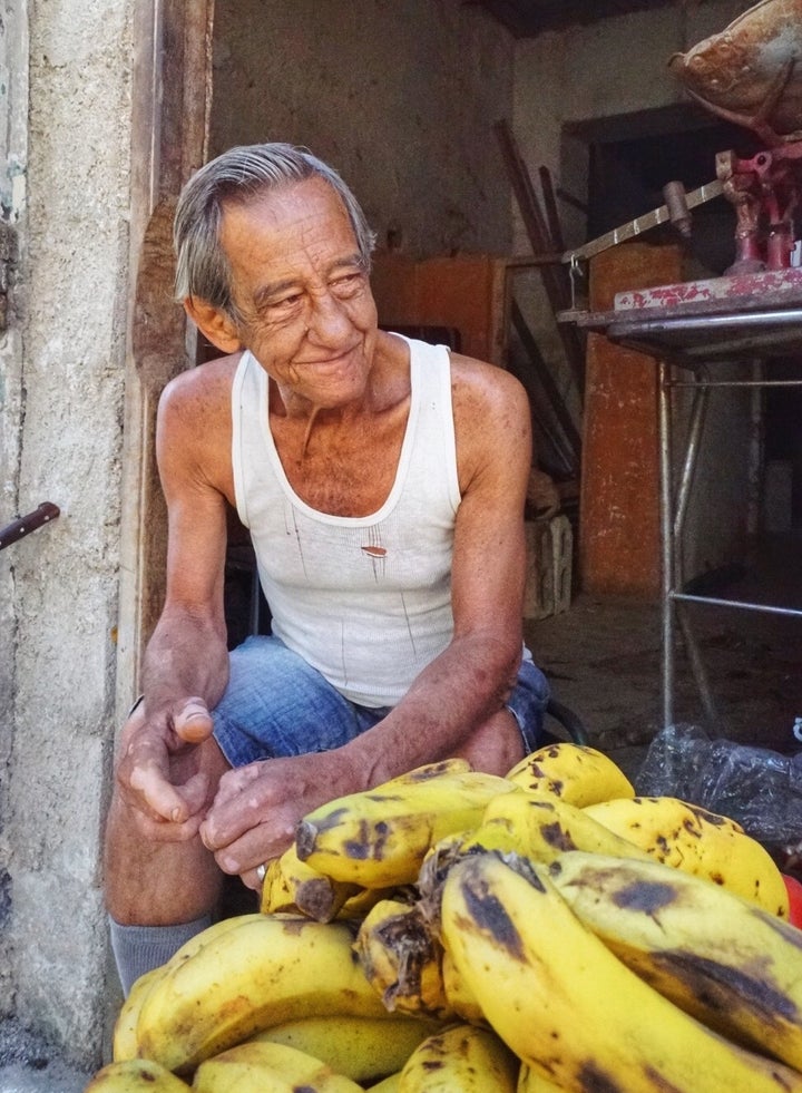 <p>A man sells bananas on the streets of Havana Vieja</p>